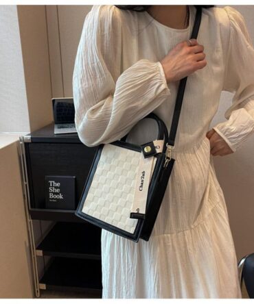 Ashrykins tape décor embossed detail square bag in Cream and Black